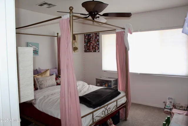 a bedroom with a bed and a ceiling fan