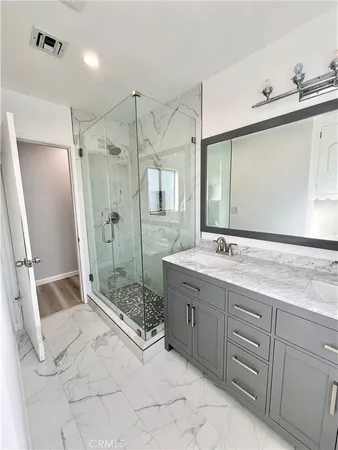 a spacious bathroom with a shower sink mirror and