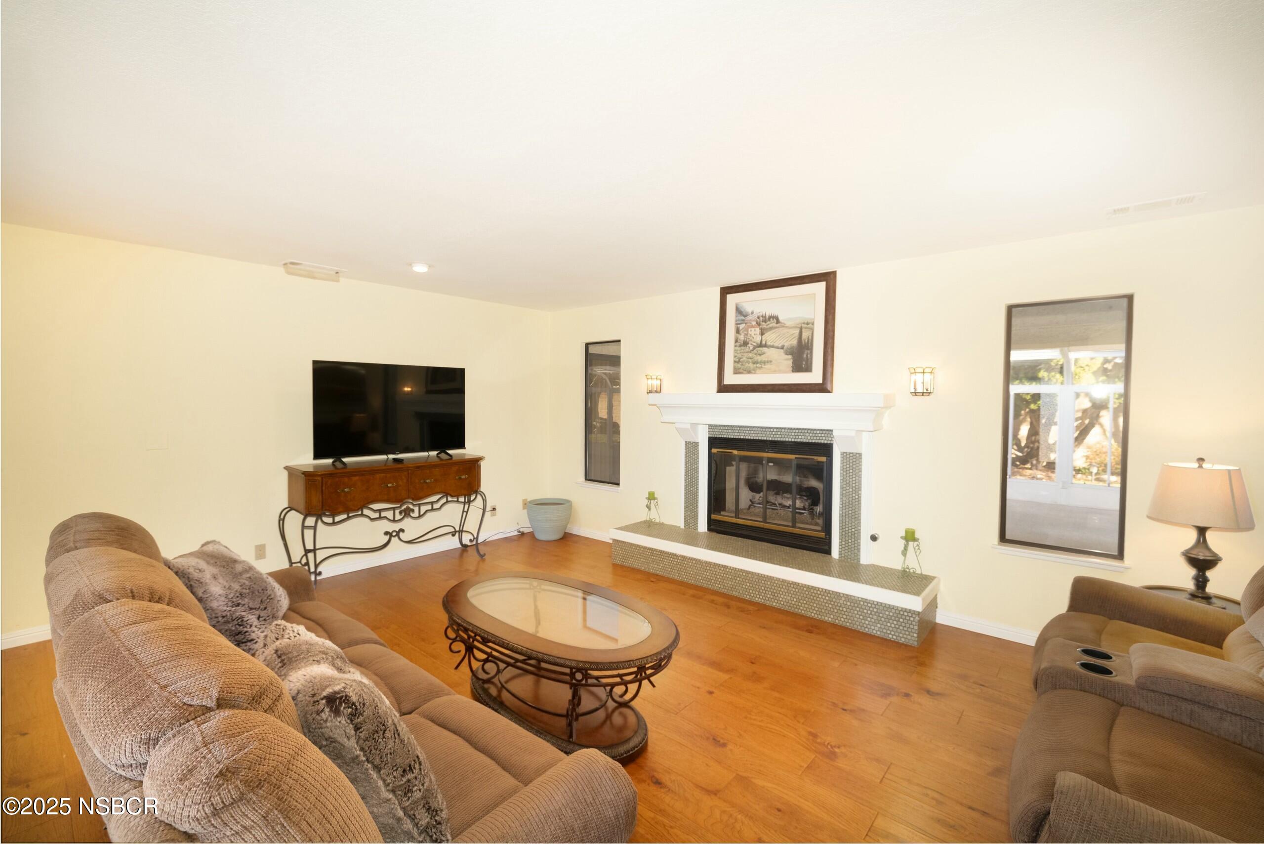 1303 Ruby Court Santa Maria, CA 93454 - Photo 2 of 22 a living room with furniture and a fireplace