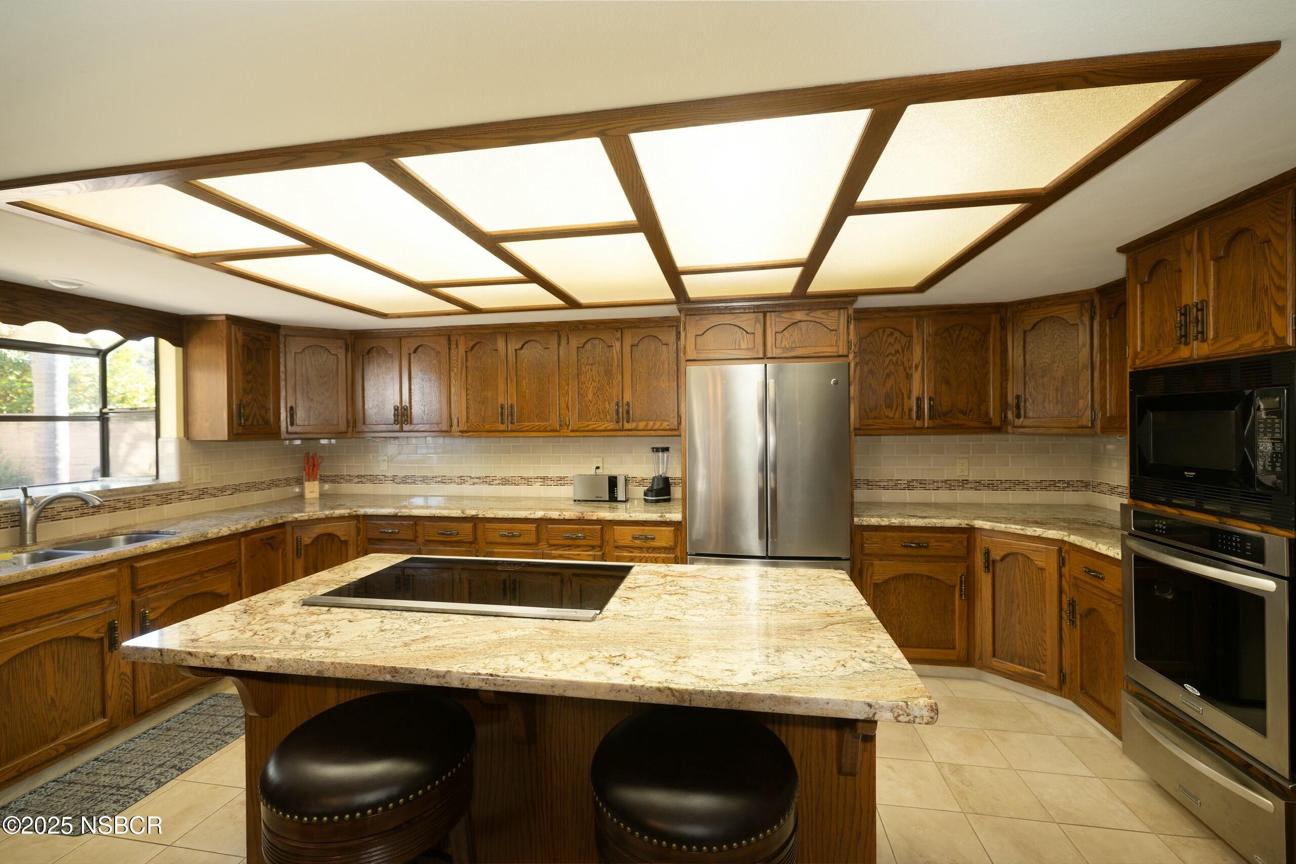 1303 Ruby Court Santa Maria, CA 93454 - Photo 4 of 22 a kitchen with a stove sink and cabinets