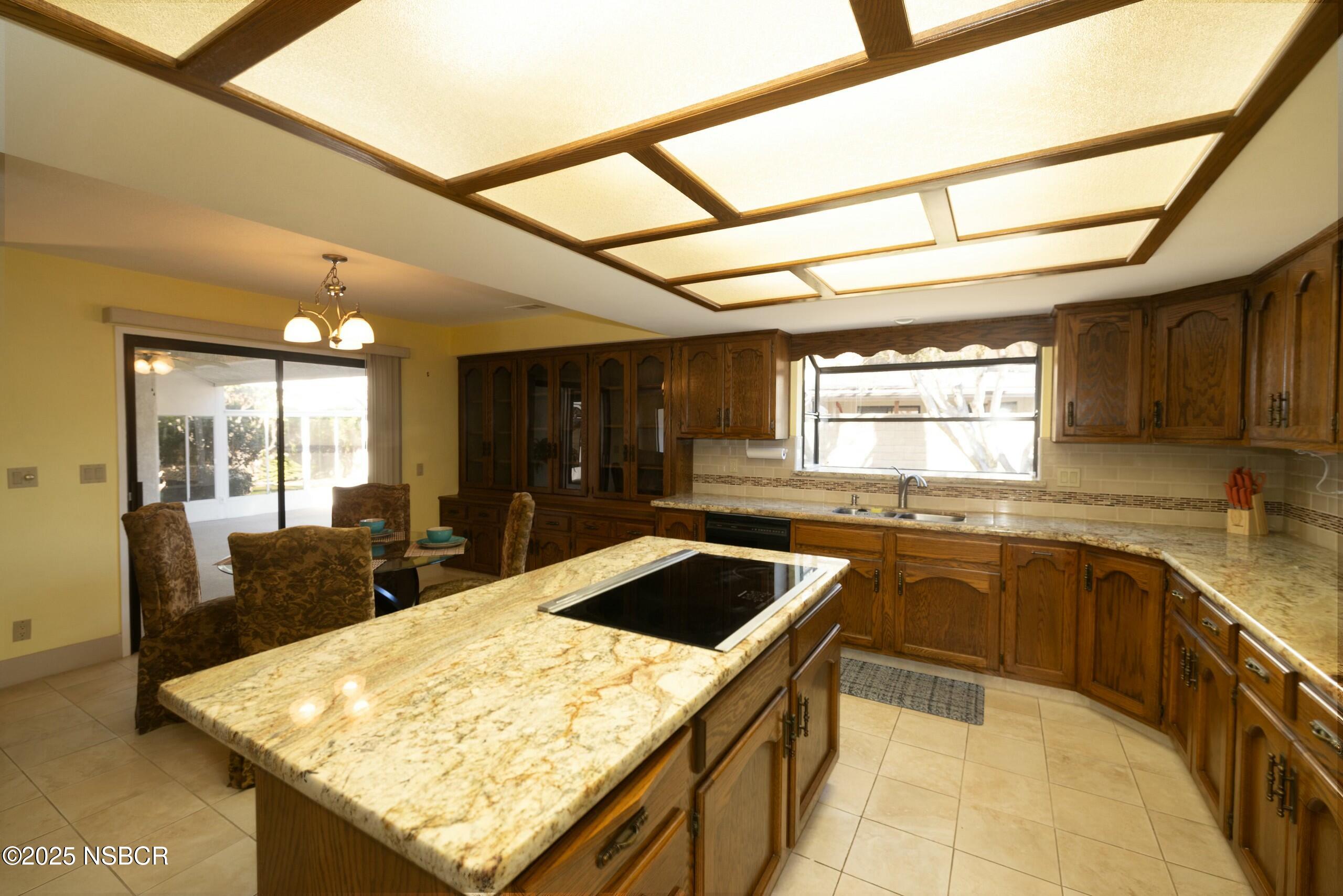 1303 Ruby Court Santa Maria, CA 93454 - Photo 5 of 22 a kitchen with stainless steel appliances granite countertop sink stove and refrigerator