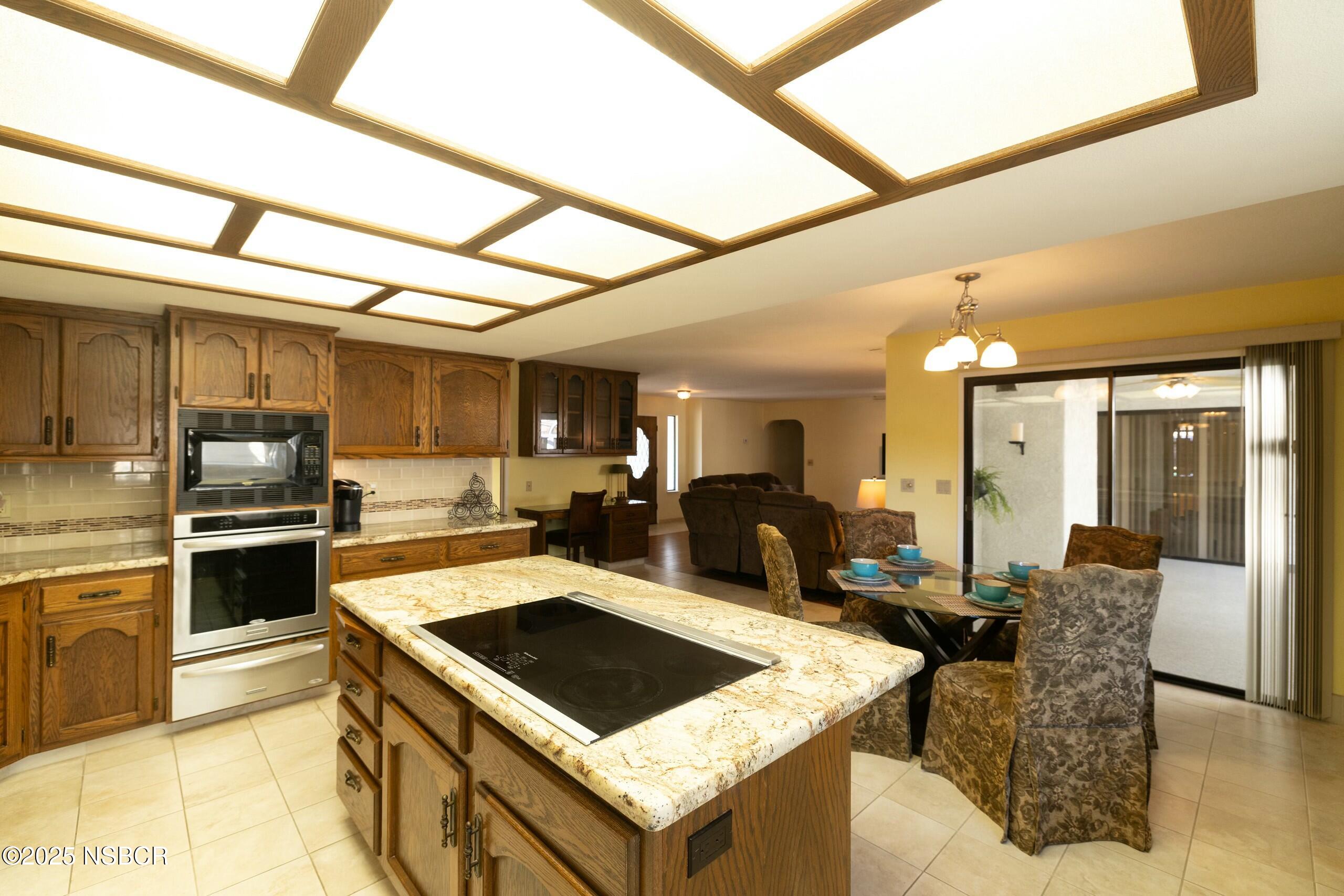 1303 Ruby Court Santa Maria, CA 93454 - Photo 6 of 22 a kitchen with stainless steel appliances granite countertop a stove and a refrigerator