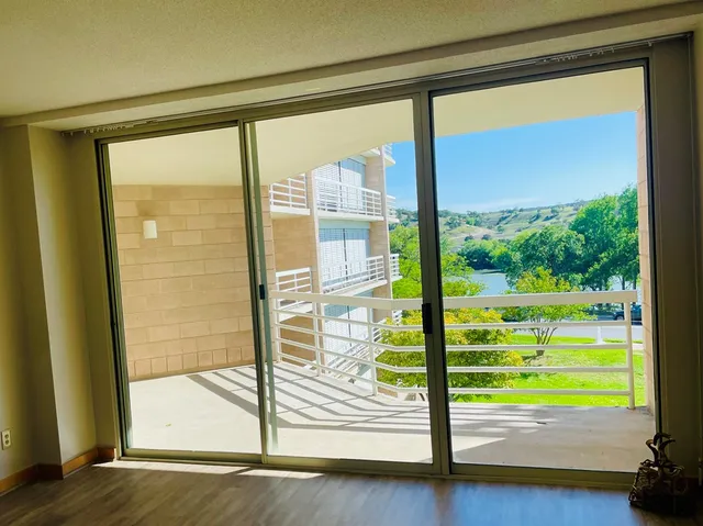 a view of a room with wooden floor and windows