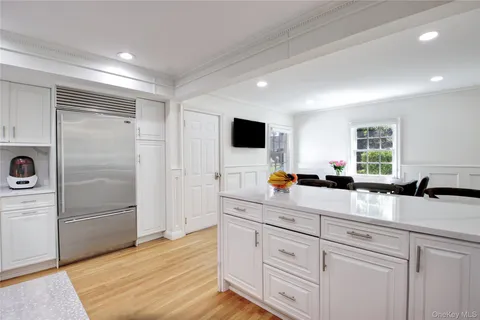a kitchen with granite countertop a refrigerator and a sink