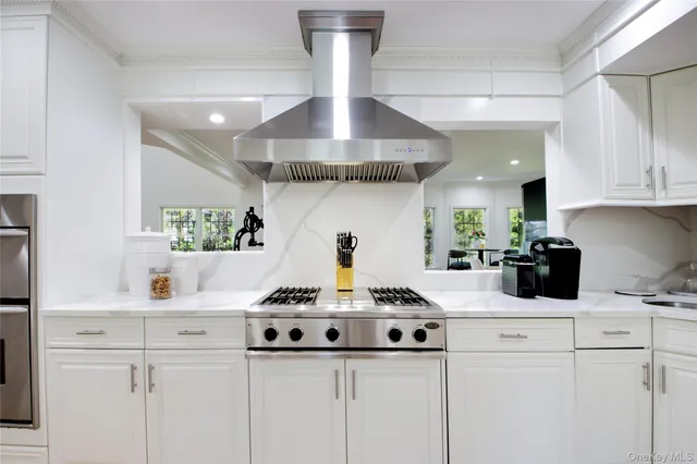 a kitchen with a stove and cabinets