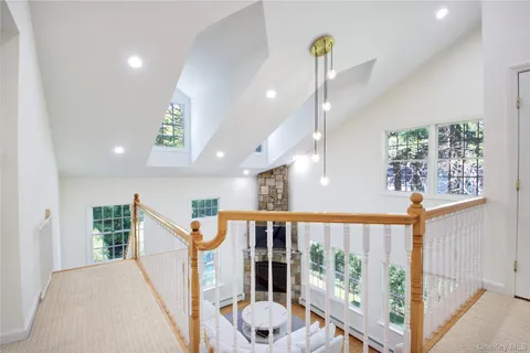 a view of a hallway with windows and stairs