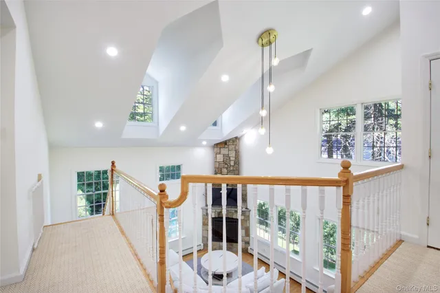 a view of a hallway with windows and stairs