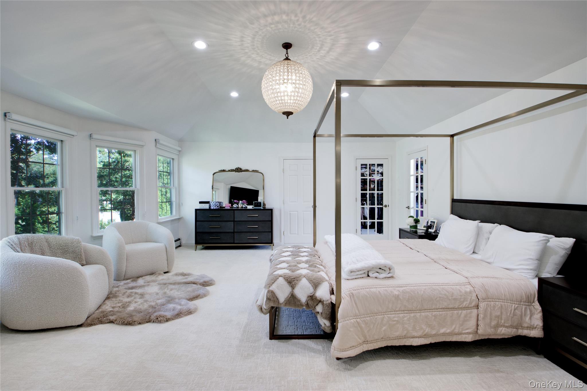 39 Squirrel Hill Road East Hills, NY 11577 - Photo 17 of 35 a bedroom with a bed and a chandelier