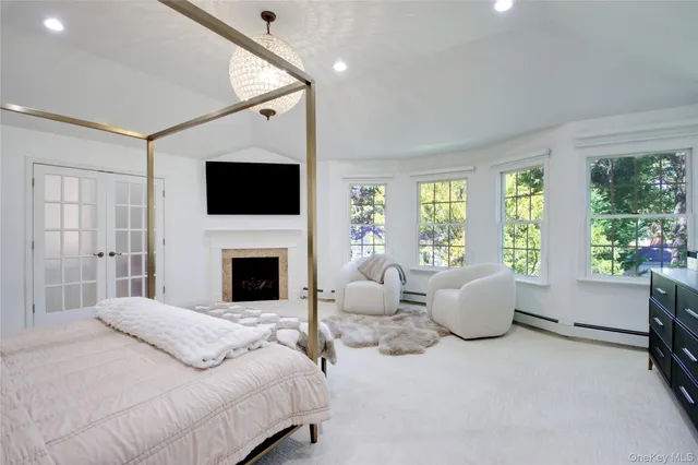 a bedroom with a large bed and a flat screen tv