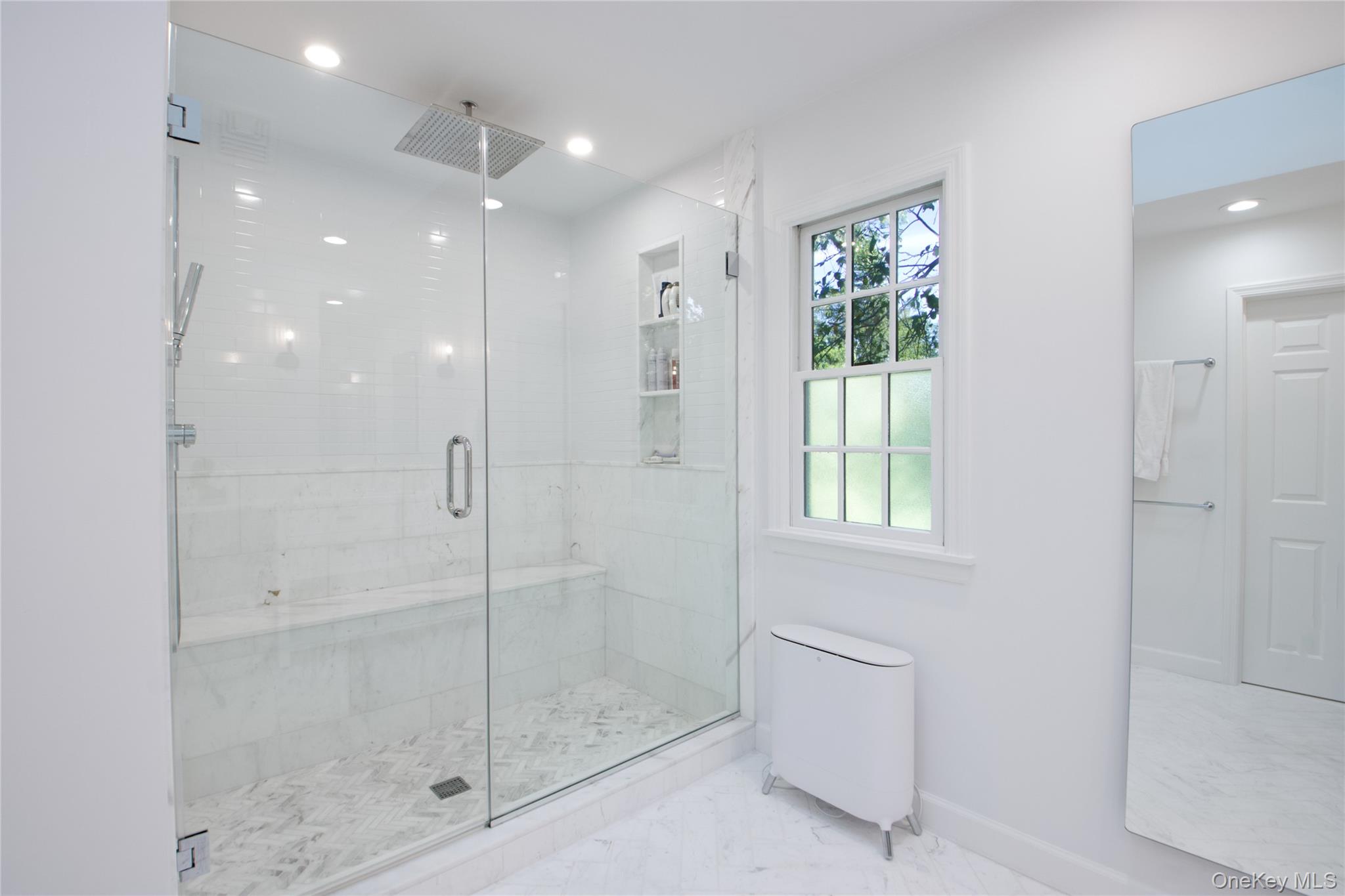 39 Squirrel Hill Road East Hills, NY 11577 - Photo 20 of 35 a bathroom with a shower and a glass door