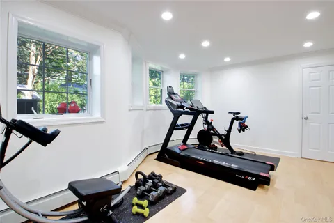 a room with gym equipment and windows