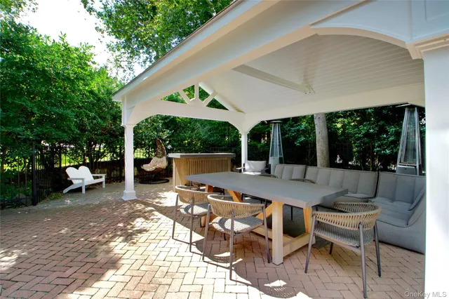 a view of a patio with table and chairs and potted plants