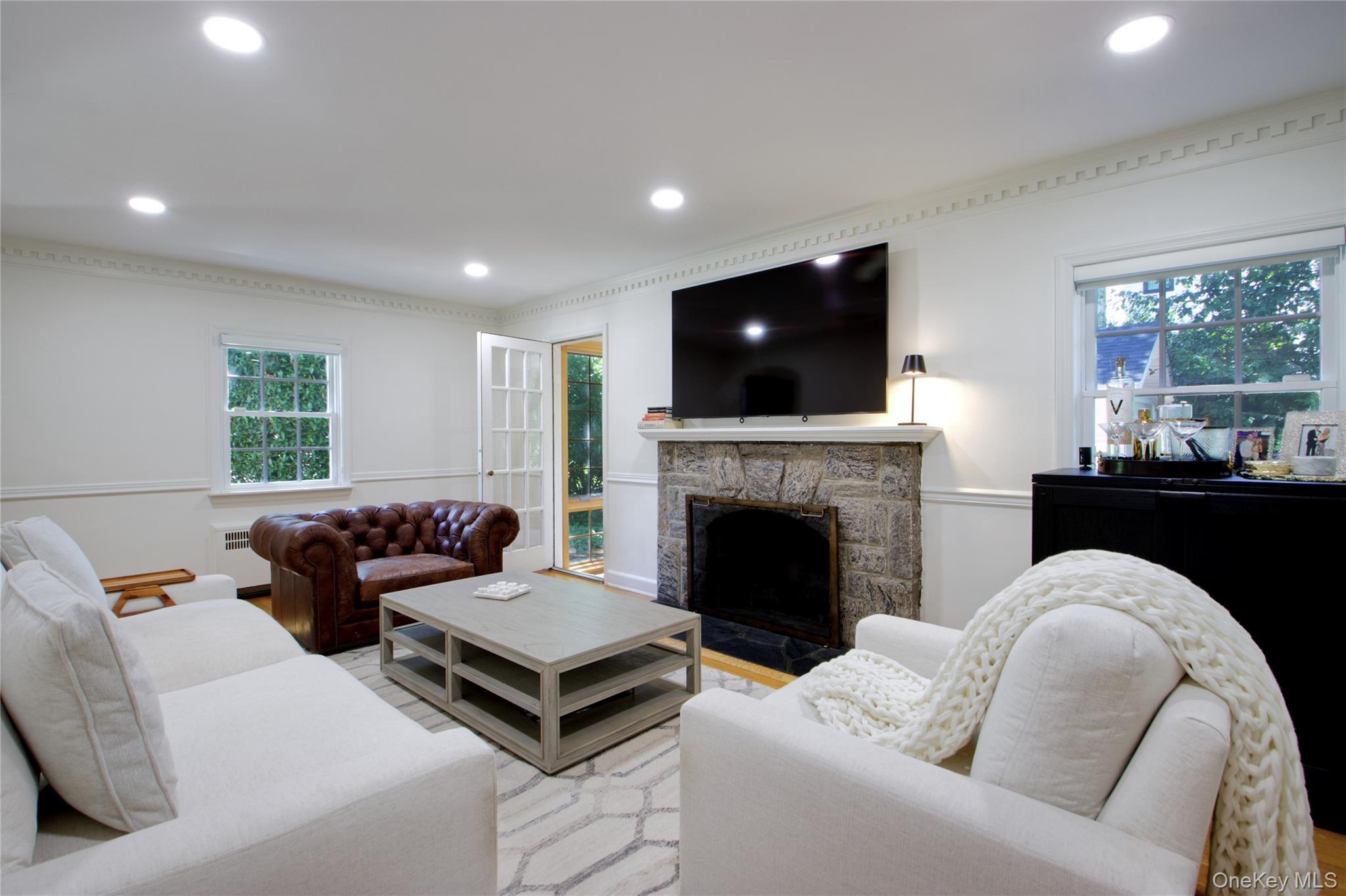 39 Squirrel Hill Road East Hills, NY 11577 - Photo 9 of 35 a living room with furniture a flat screen tv and a fireplace