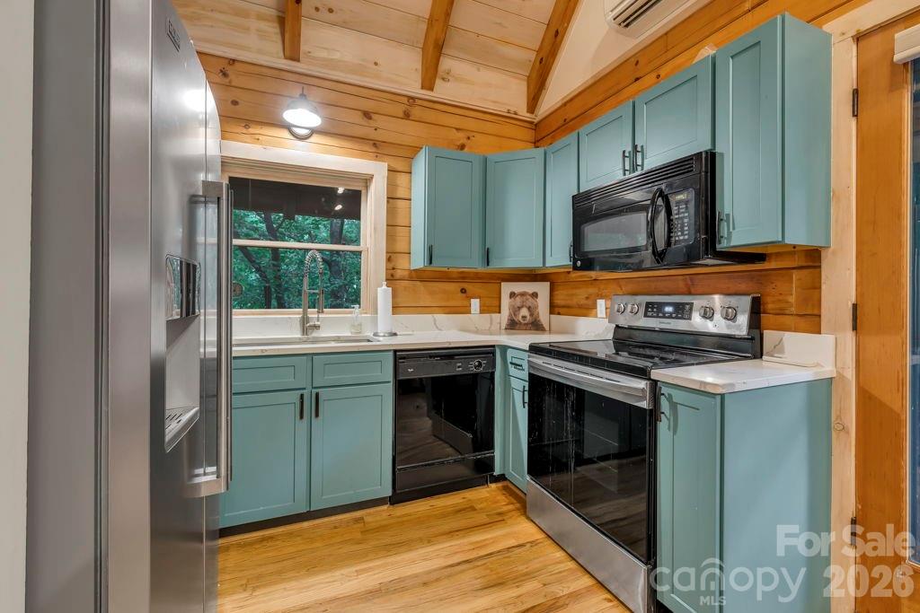 192 Dewitt Barnett Road, Unit 2 Vilas, NC 28692 - Photo 12 of 32 a kitchen with stainless steel appliances granite countertop a stove a sink and a microwave