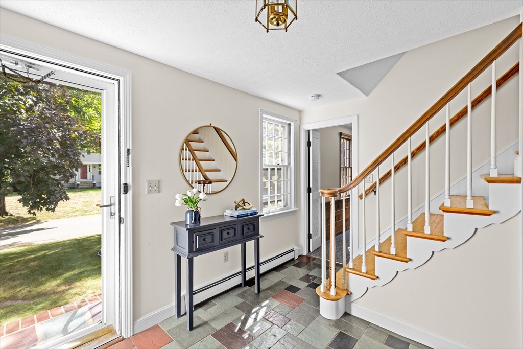 15 Presidents Road Hingham, MA 02043 - Photo 13 of 25 a view of entryway dining room and hall with wooden floor
