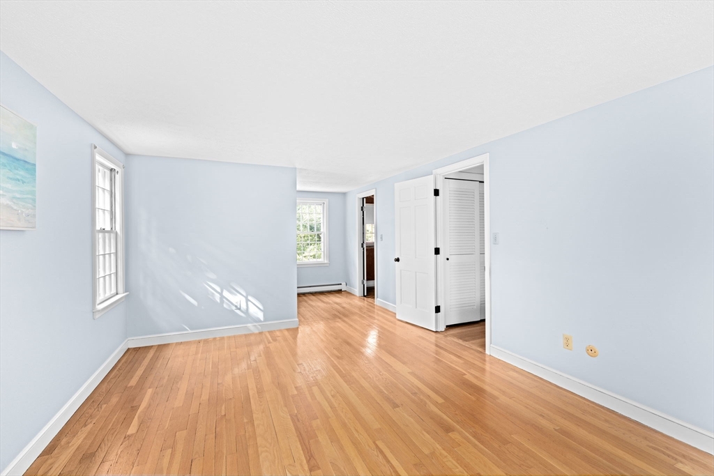 15 Presidents Road Hingham, MA 02043 - Photo 15 of 25 a view of empty room with wooden floor and fan