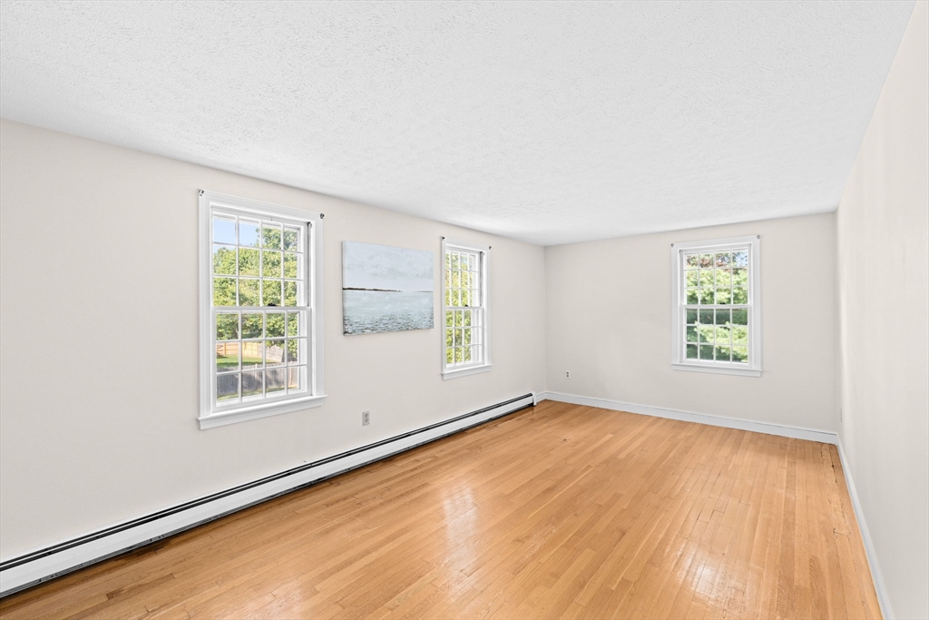 15 Presidents Road Hingham, MA 02043 - Photo 16 of 25 an empty room with wooden floor and windows
