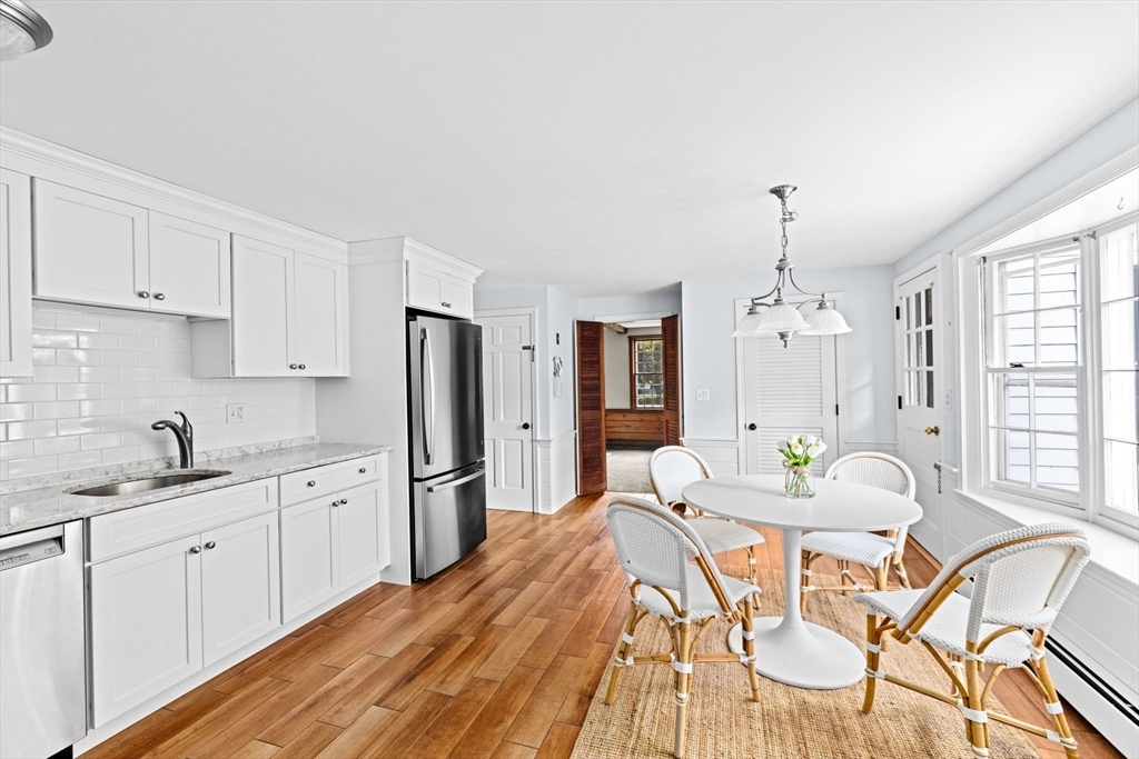 15 Presidents Road Hingham, MA 02043 - Photo 4 of 25 a kitchen with stainless steel appliances kitchen island granite countertop a sink and refrigerator