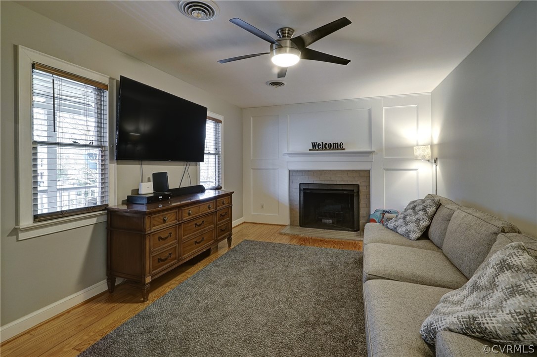 7206 Barkbridge Road Chesterfield, VA 23832 - Photo 12 of 36 a living room with furniture a flat screen tv and a fireplace
