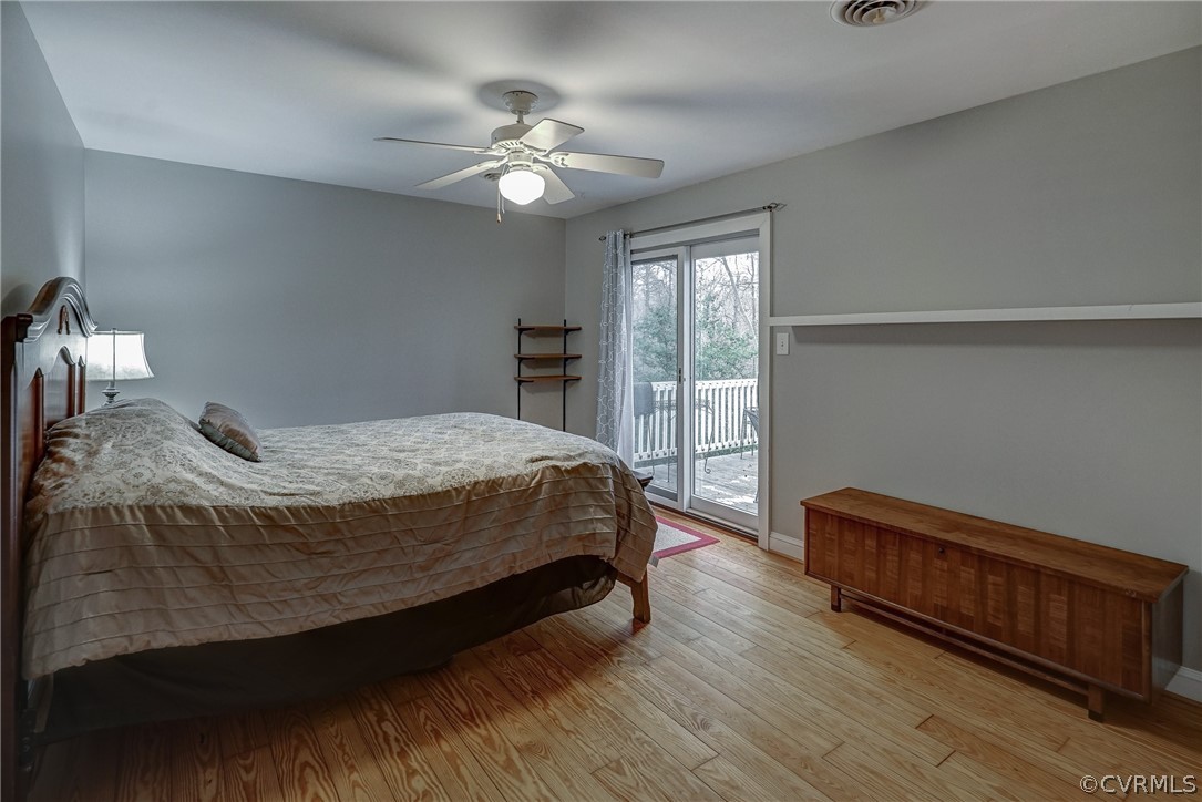 7206 Barkbridge Road Chesterfield, VA 23832 - Photo 18 of 36 a spacious bedroom with a bed and a chandelier