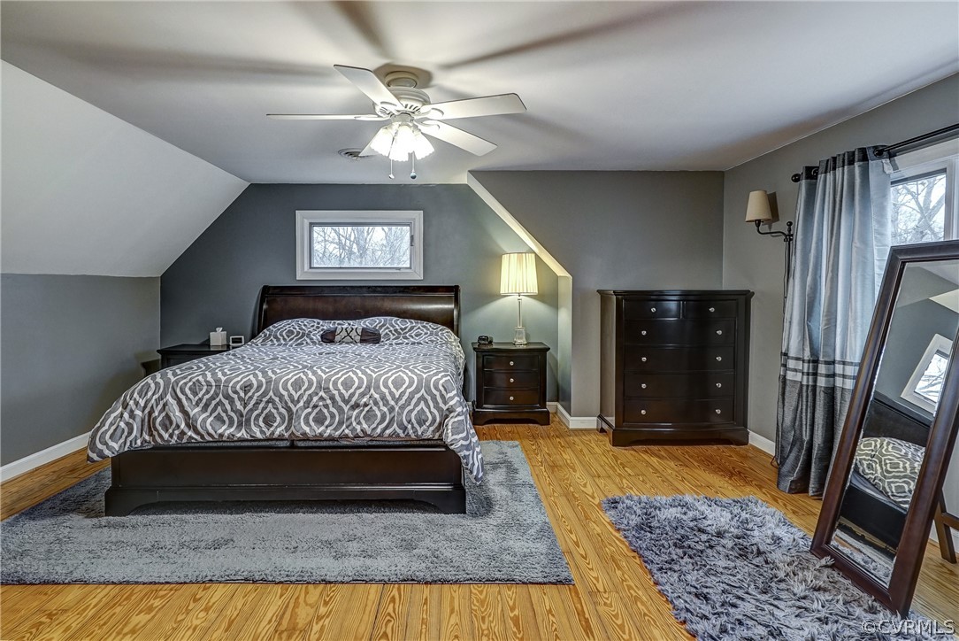 7206 Barkbridge Road Chesterfield, VA 23832 - Photo 23 of 36 a bedroom with a large bed and a chandelier
