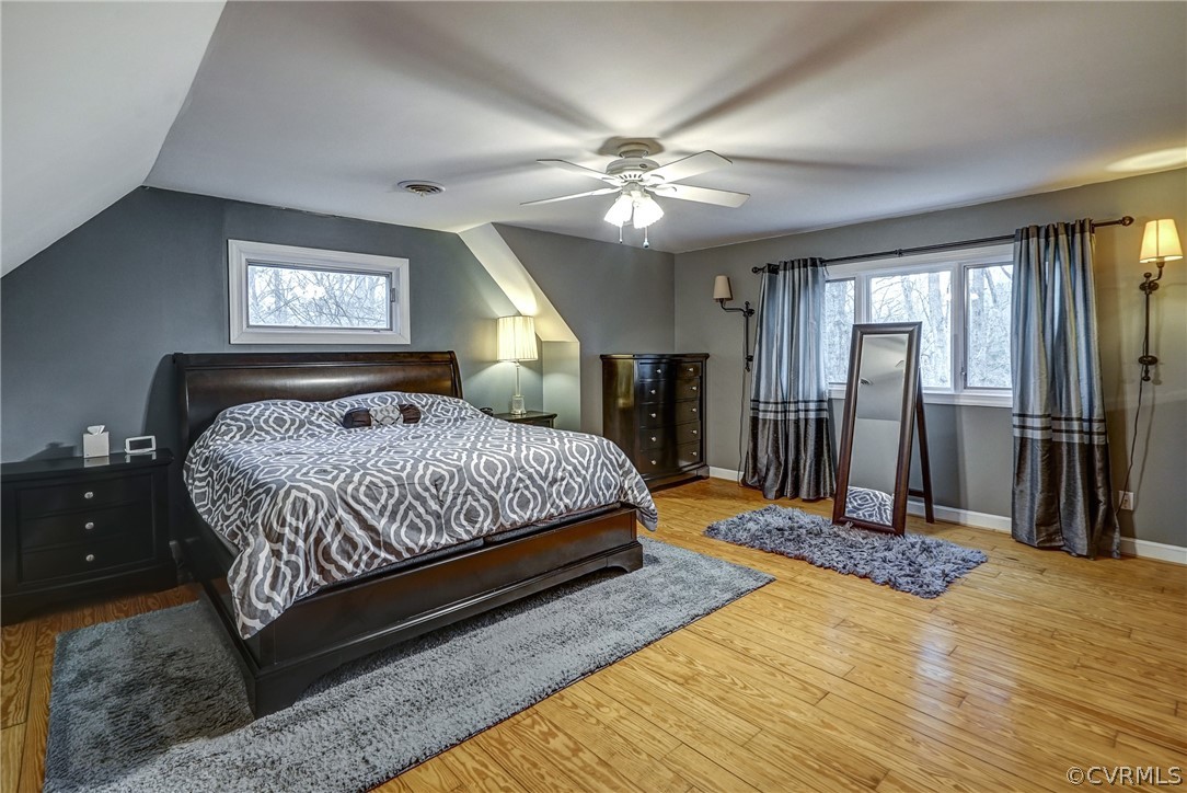 7206 Barkbridge Road Chesterfield, VA 23832 - Photo 25 of 36 a bedroom with a large bed and a chandelier
