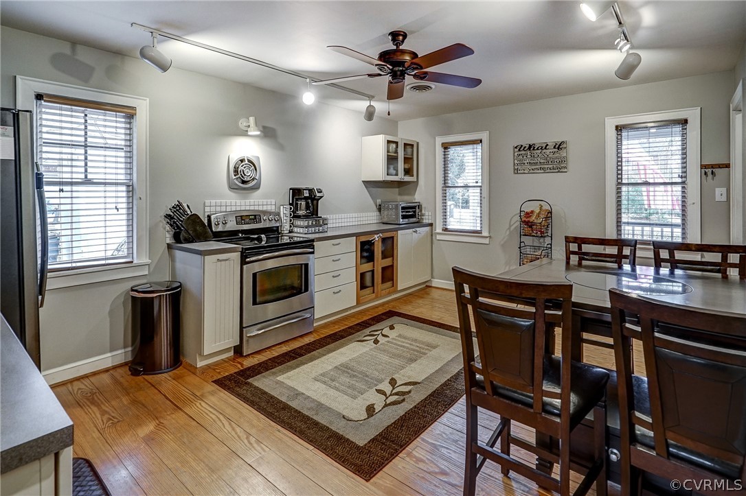 7206 Barkbridge Road Chesterfield, VA 23832 - Photo 6 of 36 a kitchen with a stove a sink a dining table and chairs