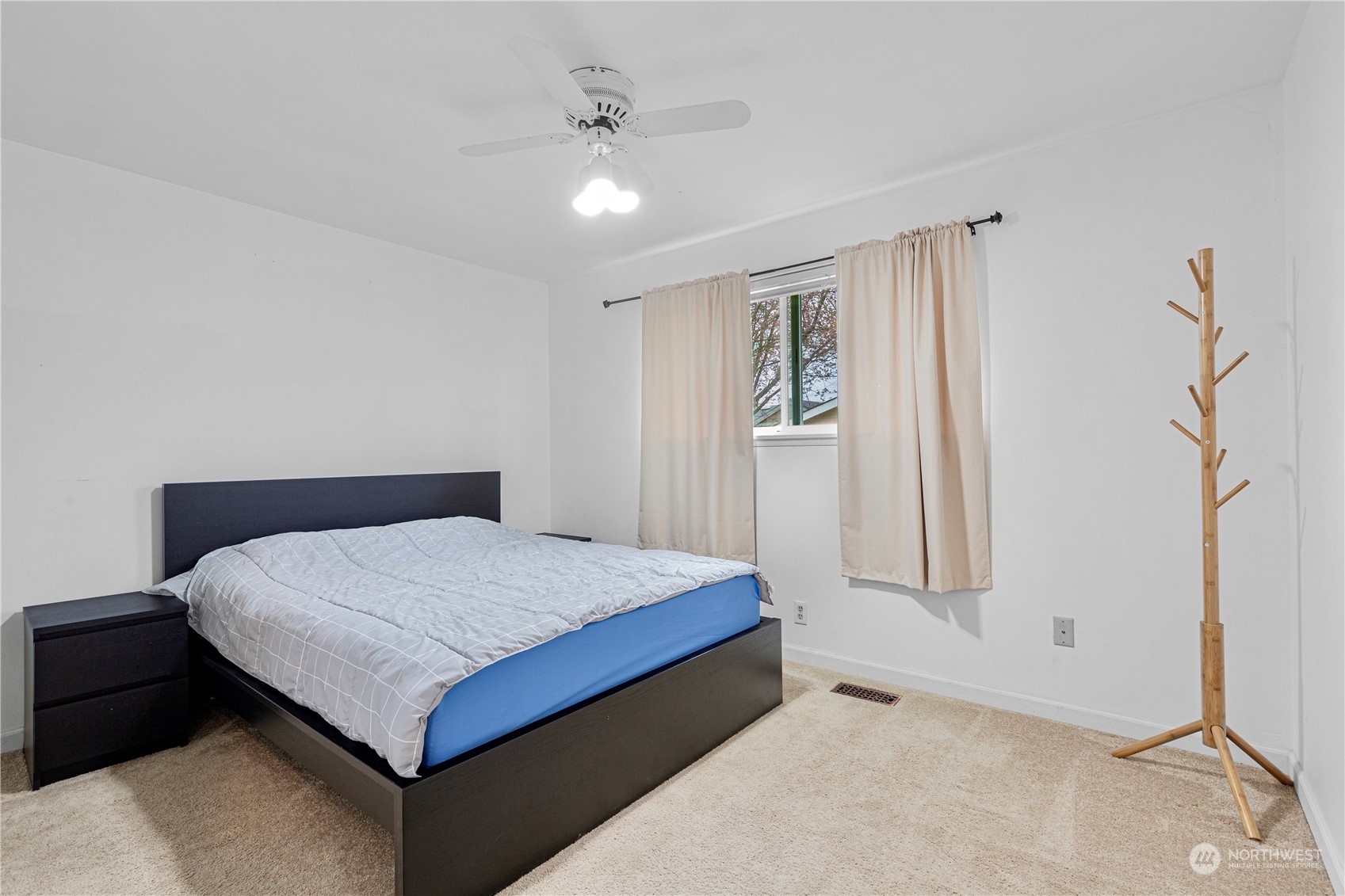 3724 Northeast 9th Street Renton, WA 98056 - Photo 12 of 16 a bed sitting in a spacious bedroom next to a window and a chandelier