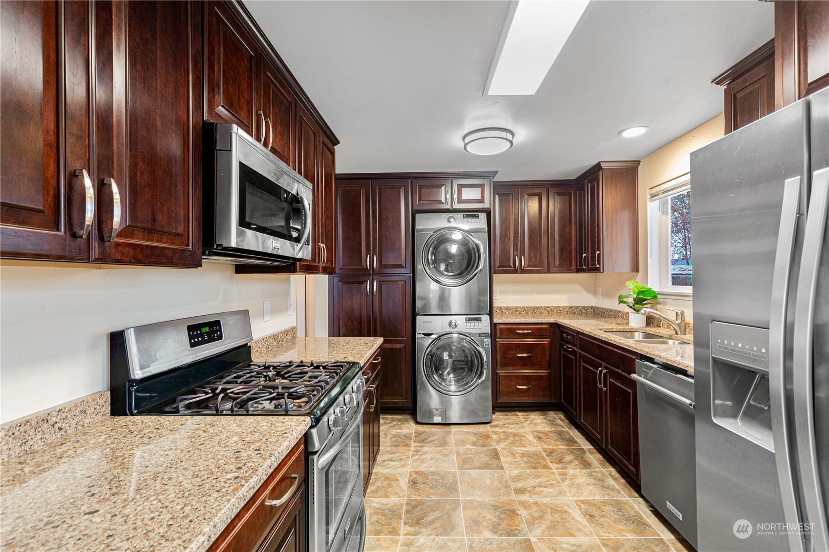 3724 Northeast 9th Street Renton, WA 98056 - Photo 7 of 16 a kitchen with stainless steel appliances granite countertop a stove refrigerator and cabinets