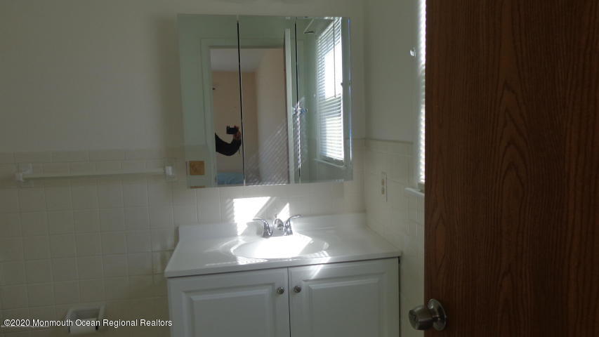2 Sheridan Road Toms River, NJ 08757 - Photo 11 of 14 a bathroom with a sink and mirror