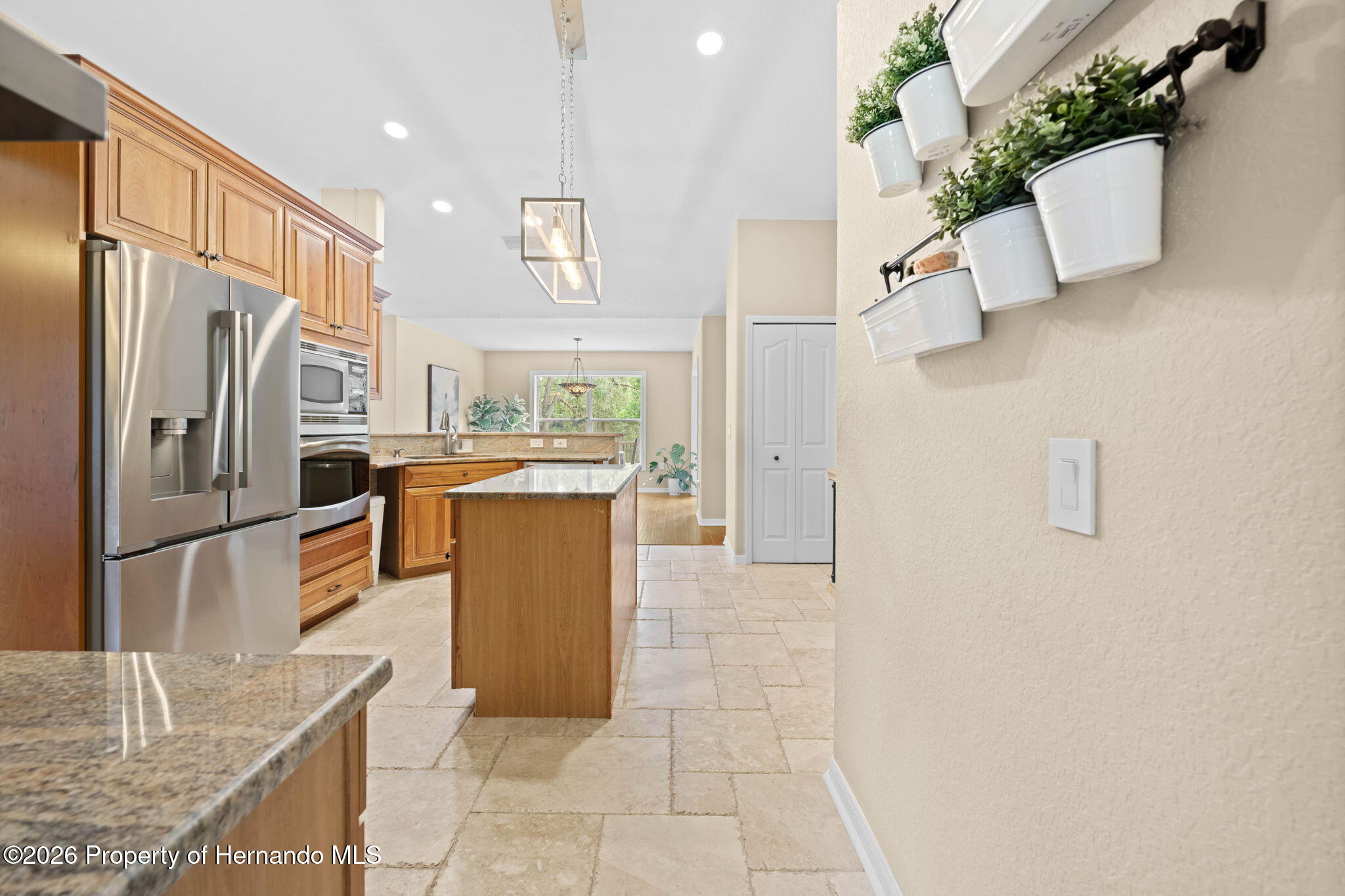 14220 Ermine Owl Road Brooksville, FL 34614 - Photo 25 of 54 a kitchen with stainless steel appliances granite countertop a refrigerator a stove and a sink
