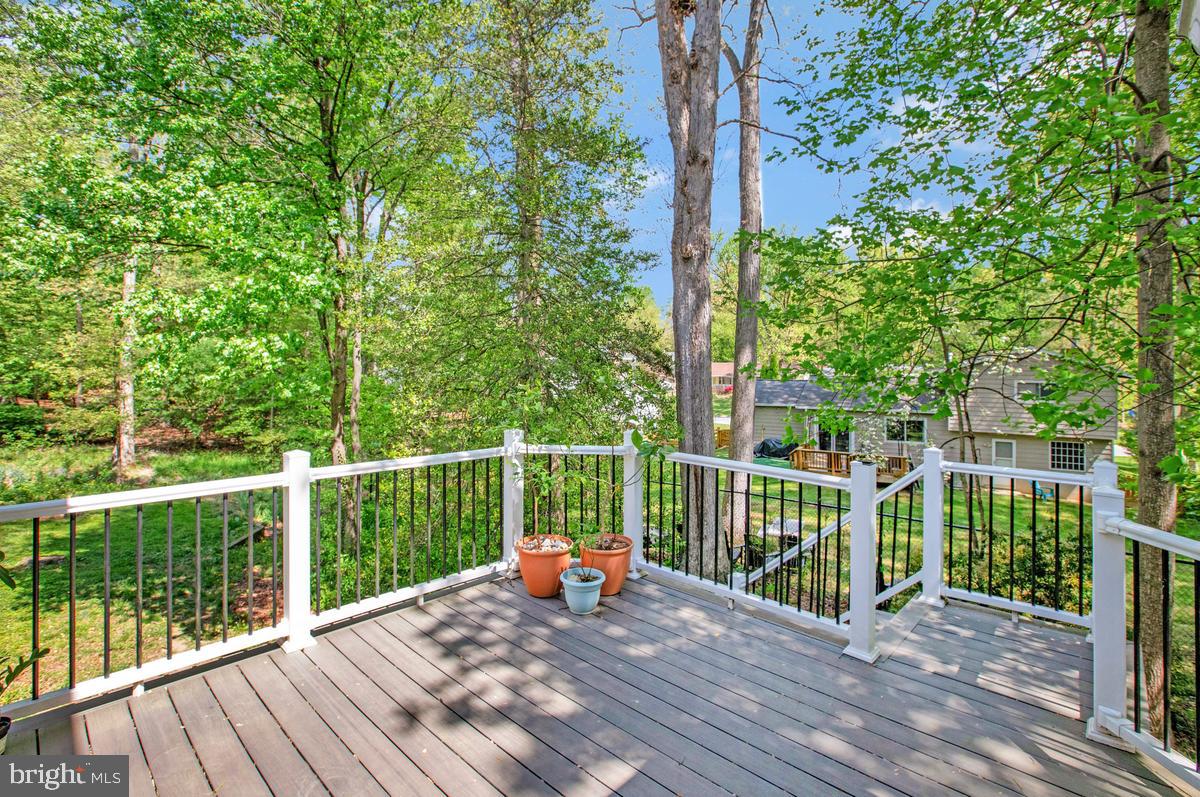 16311 Dahl Road Laurel, MD 20707 - Photo 20 of 54 Serene deck surrounded by lush greenery.