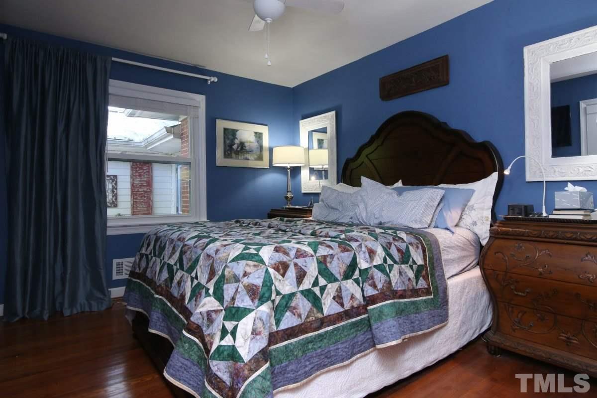 1106 Southerlund Road Garner, NC 27529 - Photo 12 of 24 a bedroom with a bed lamp and a window
