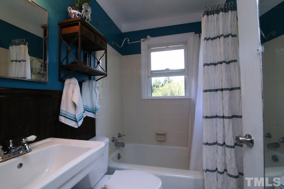 1106 Southerlund Road Garner, NC 27529 - Photo 15 of 24 a bathroom with a sink toilet and shower