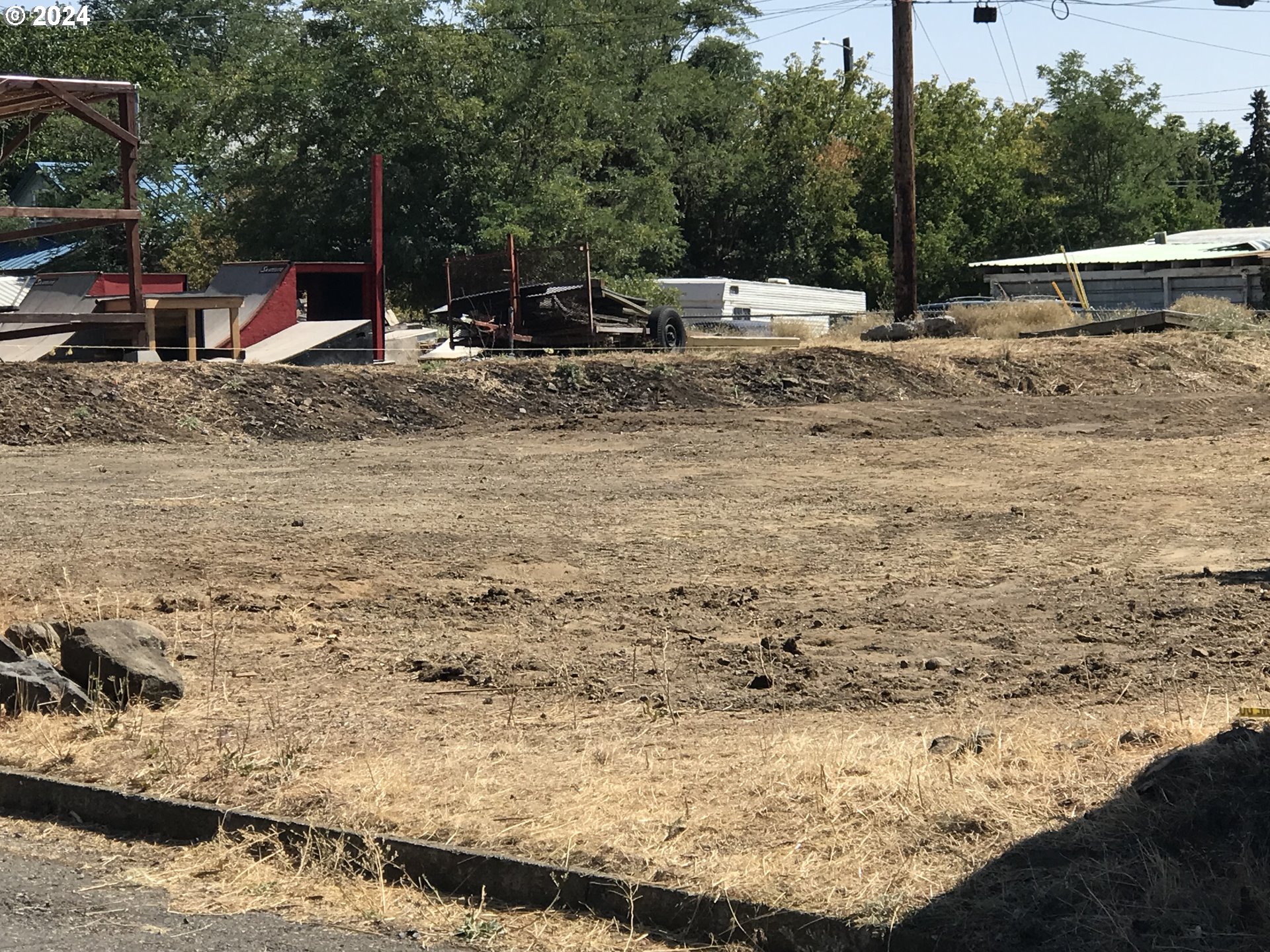 610 Northeast 2nd Street Goldendale, WA 98620 - Photo 2 of 13 a view of yard with swimming pool and trees