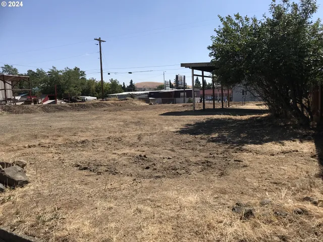 a view of a house with wooden fence