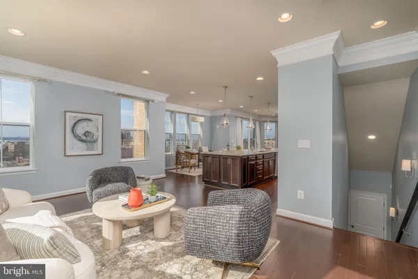 a living room with furniture and kitchen view