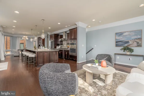 a kitchen with a dining table chairs stainless steel appliances and cabinets