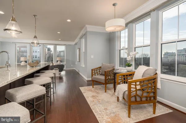 a dining room with furniture and wooden floor