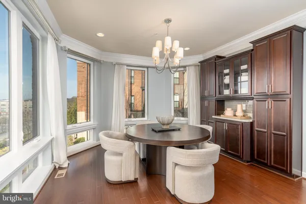 a dining room with furniture and a chandelier