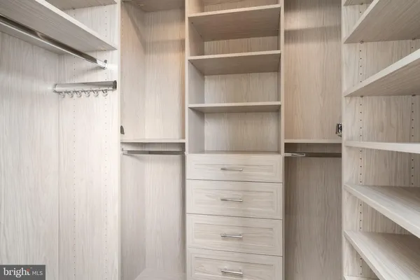 a bathroom with a granite countertop sink a mirror and shower