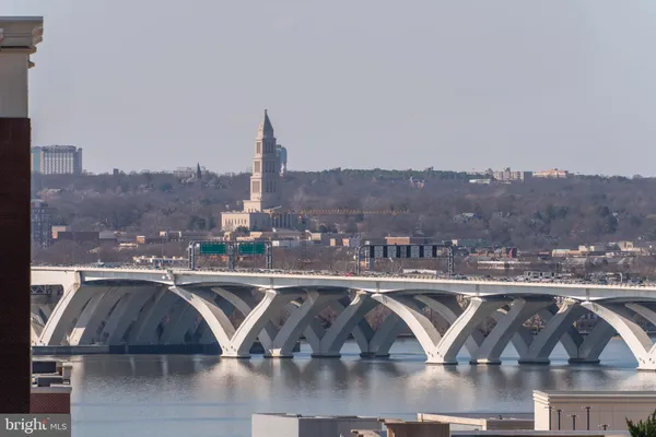 an aerial view of residential houses with outdoor space and seating