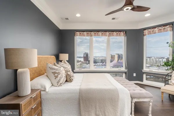 a bedroom with furniture and a large window