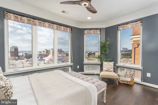 a bedroom with a large bed and wooden floor