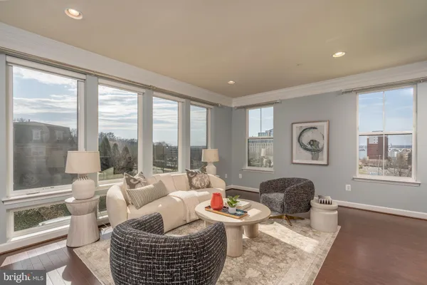 a kitchen with stainless steel appliances granite countertop table chairs sink and cabinets