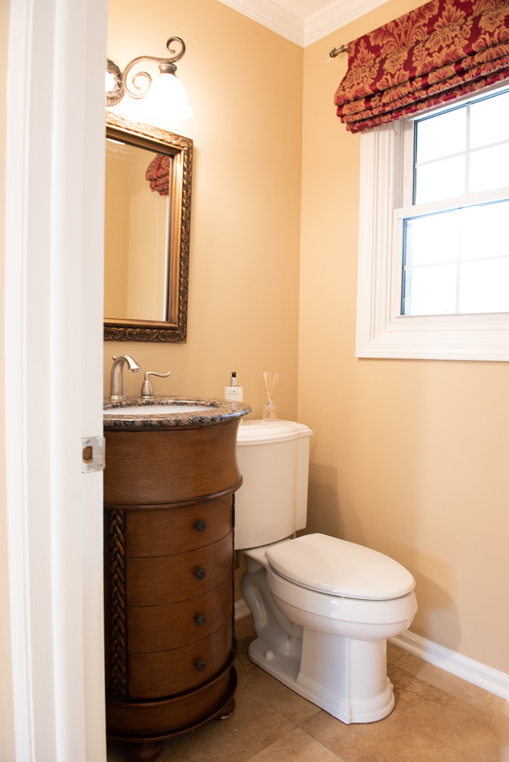227 Country Club Drive Addison, IL 60101 - Photo 13 of 39 a bathroom with a toilet sink and mirror