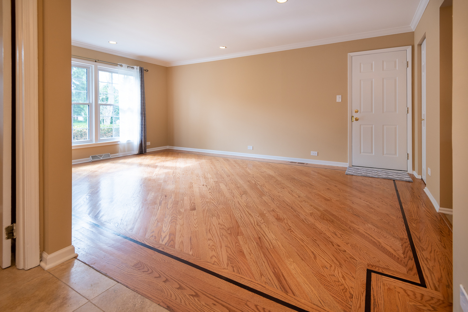 227 Country Club Drive Addison, IL 60101 - Photo 14 of 39 a view of an empty room with wooden floor and a window