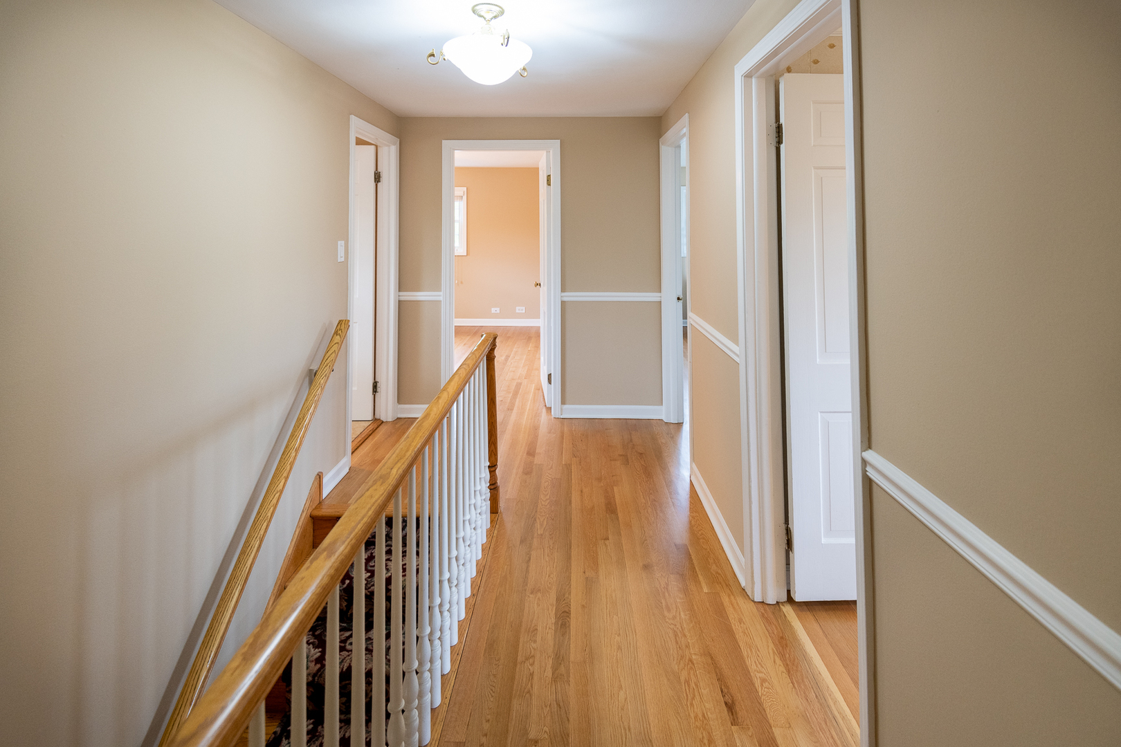 227 Country Club Drive Addison, IL 60101 - Photo 18 of 39 a view of a hallway with wooden floor