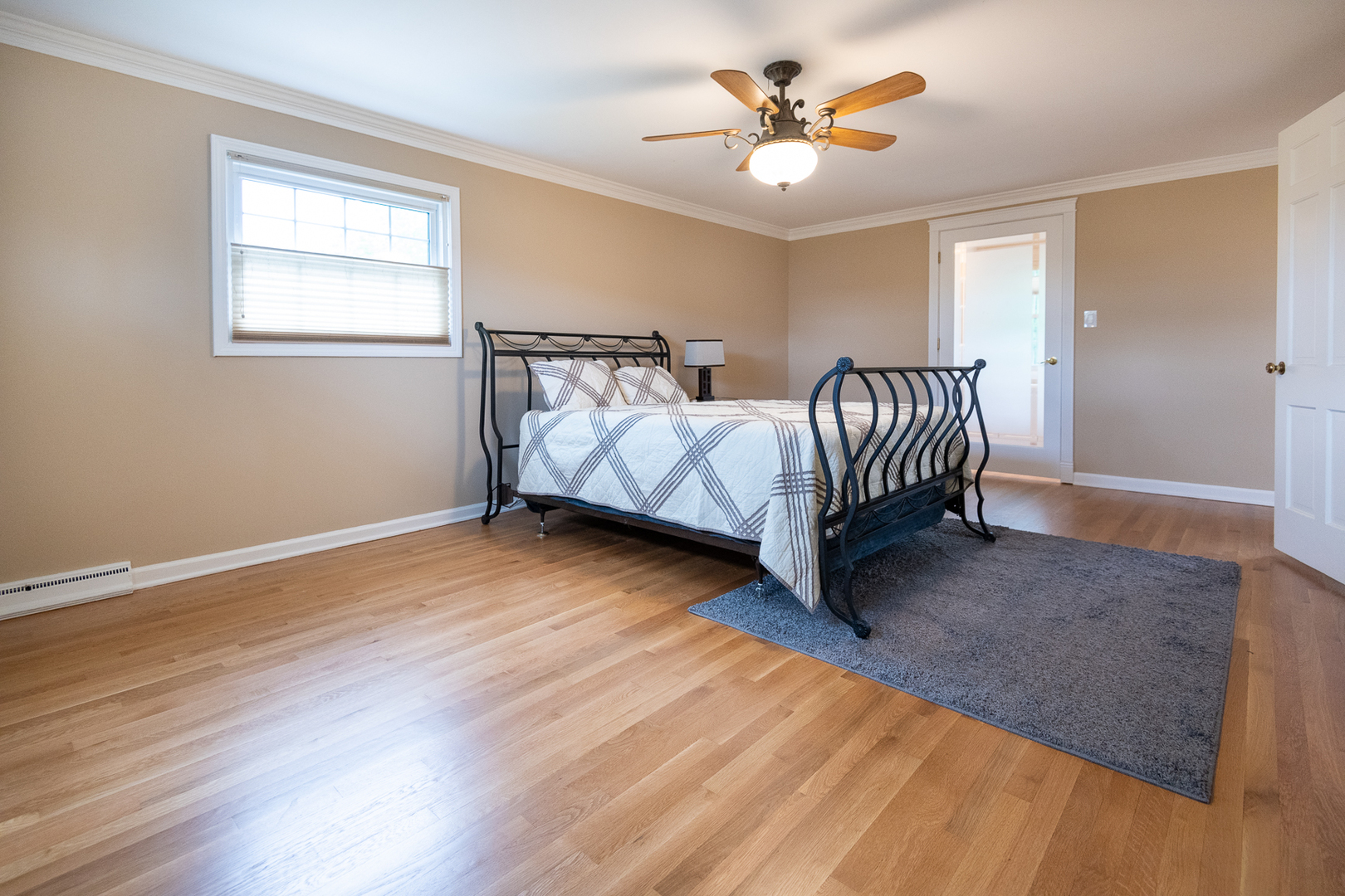 227 Country Club Drive Addison, IL 60101 - Photo 20 of 39 a spacious bedroom with a bed and a chandelier