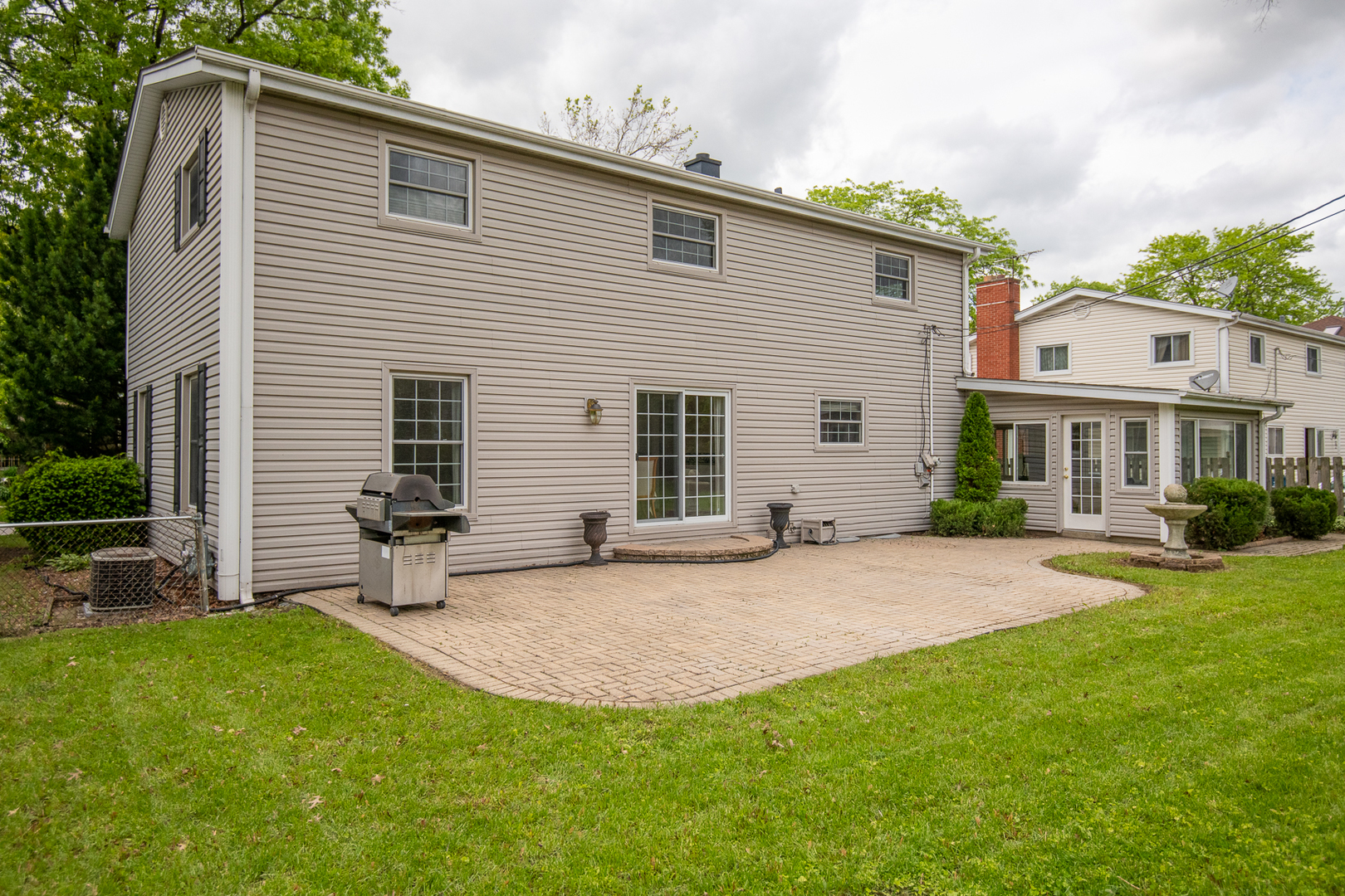 227 Country Club Drive Addison, IL 60101 - Photo 38 of 39 a backyard of a house with table and chairs